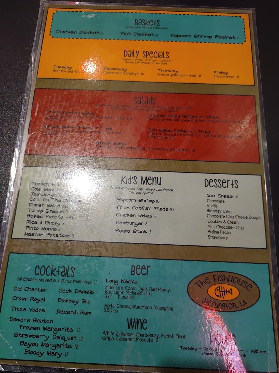 Seafood restaurant menu beside a table setting.